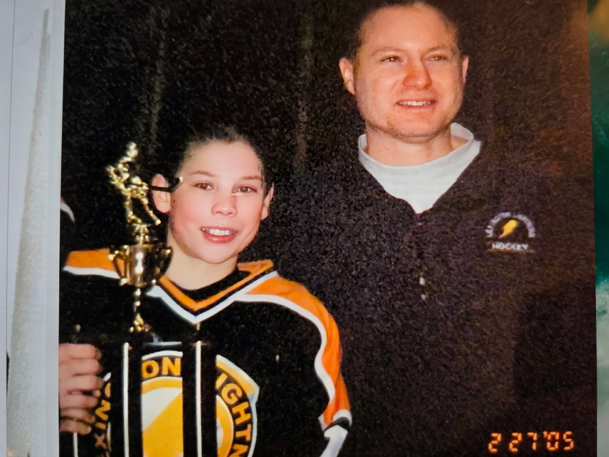 Eric and Justin celebrating a hockey tournament win together